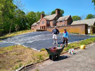 Tarps being laid by John Colgan and Alison Crowther
